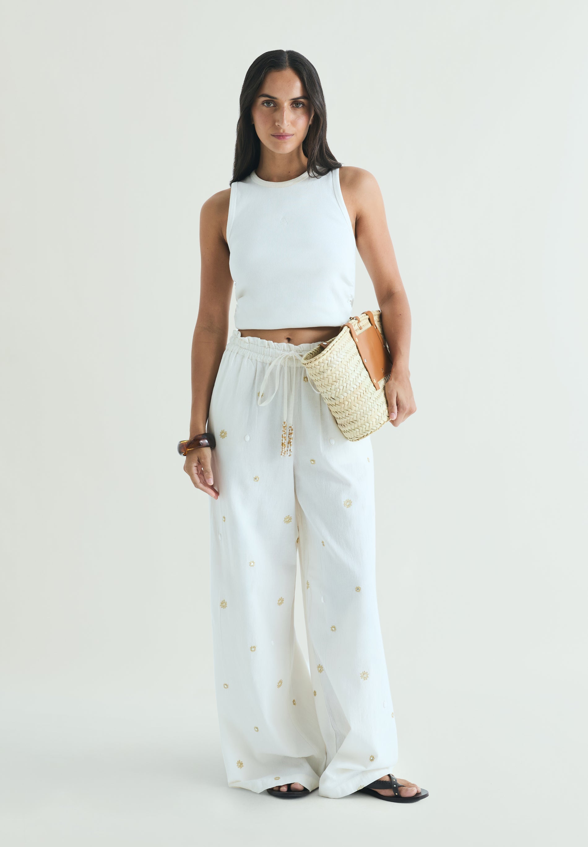 TROUSERS WITH METALLIC DETAILS