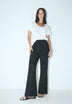 TROUSERS WITH PERFORATED DETAILS