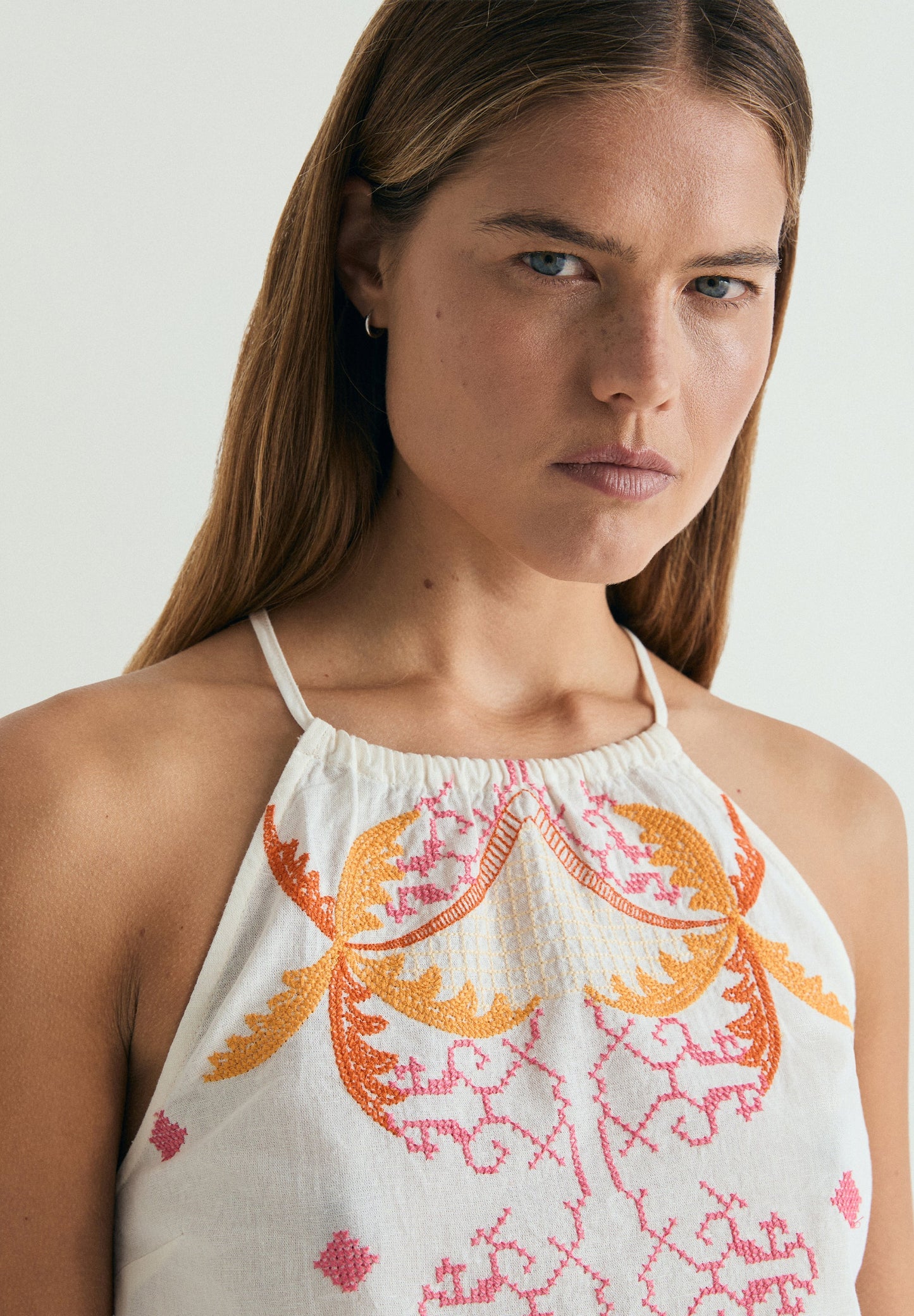 RUFFLED HALTER TOP WITH EMBROIDERY