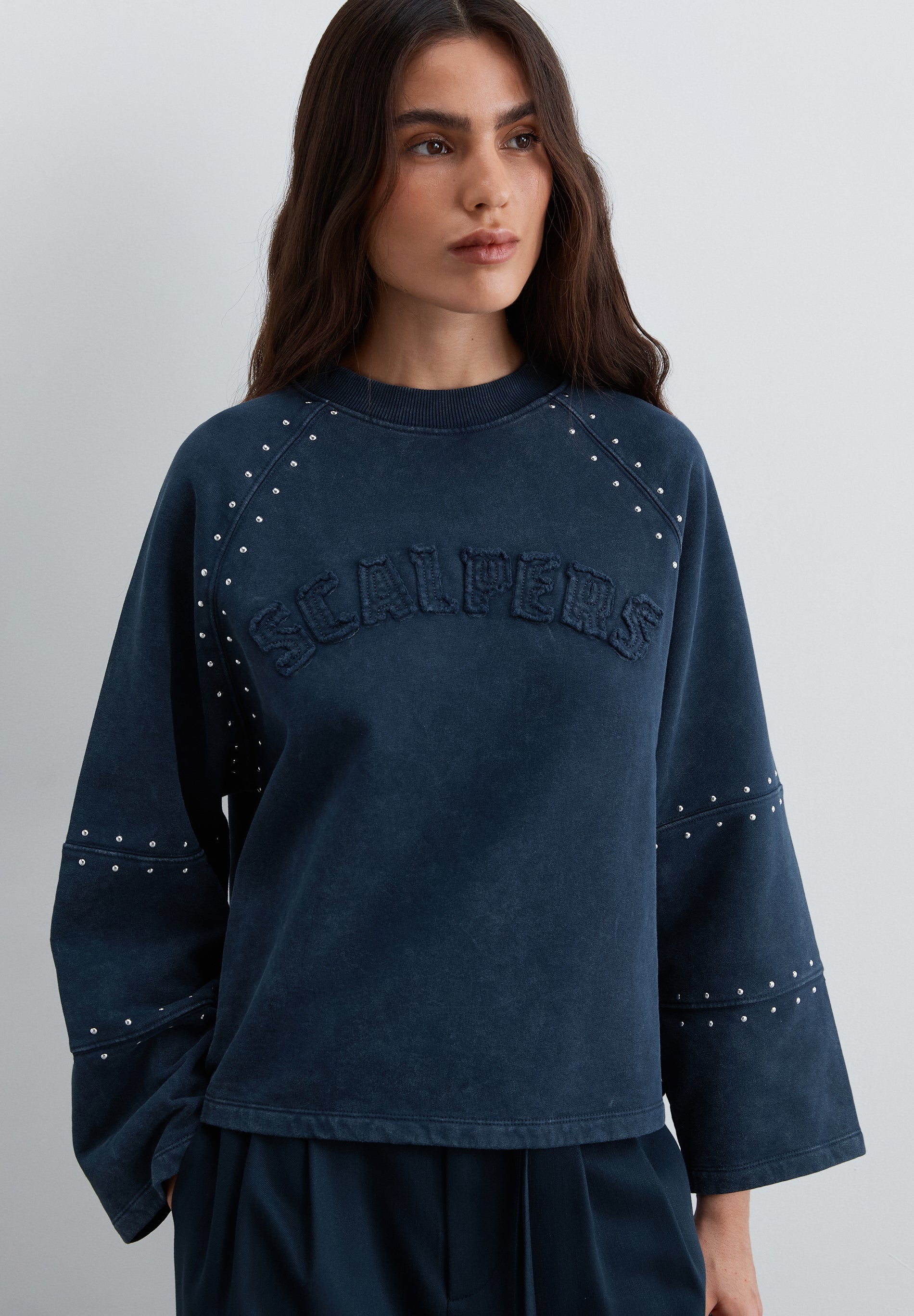 SWEATSHIRT WITH STUDS AND LOGO PATCH